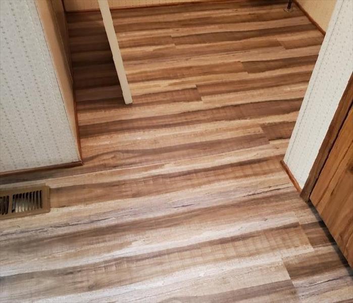 Photo is showing the new flooring installed back in the laundry room.