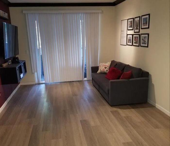 Photo is showing new gray vinyl plank floor installed