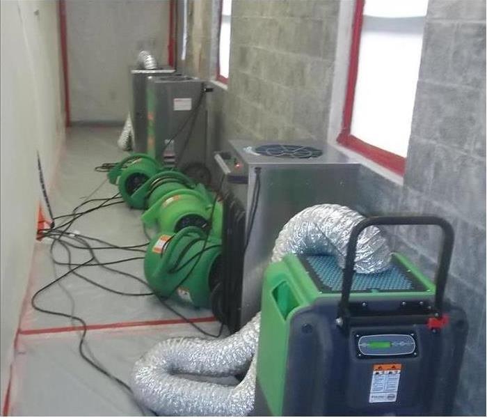 Photo is showing drying equipment, drying a block wall.