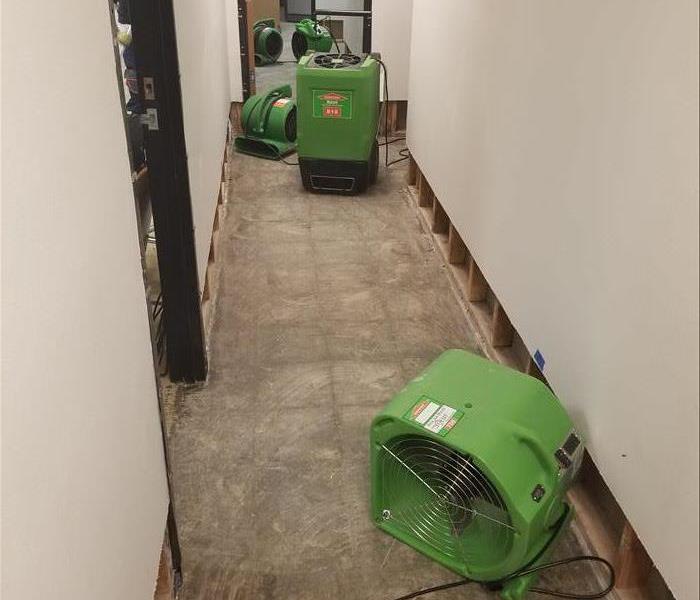 SERVPRO drying equipment placed on a commercial job in a hall way