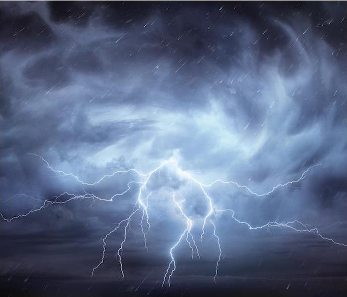 Photo is showing lightning in a cloudy and dark sky.