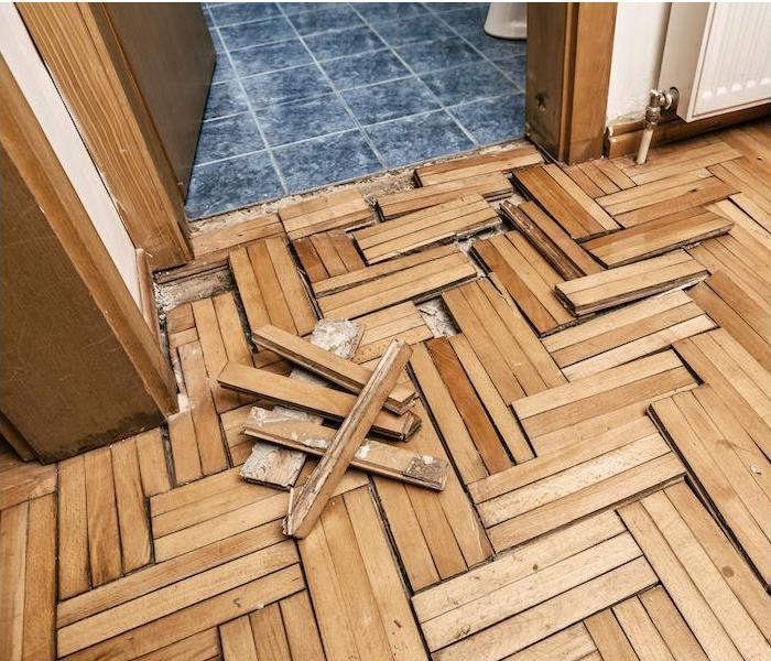 Wood Floor Water Damaged. Warped and Lifting