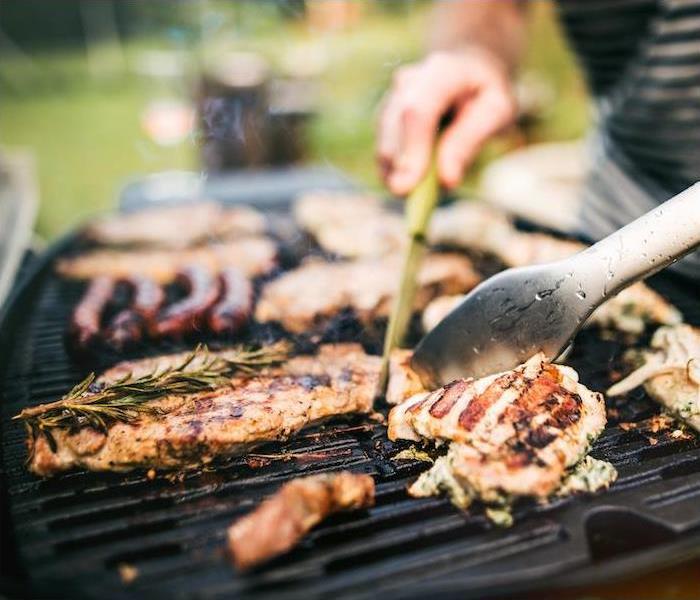 Photo is showing food on a BBQ grill.